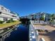 Exterior view of a waterfront condo featuring outdoor lounge chairs and waterfront scenery at 6916 Stonesthrow N Cir # 9103, St Petersburg, FL 33710