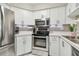 Modern kitchen featuring stainless steel appliances and bright white cabinets at 6916 Stonesthrow N Cir # 9103, St Petersburg, FL 33710
