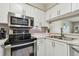 Stylish kitchen featuring stainless steel appliances and a convenient breakfast bar at 6916 Stonesthrow N Cir # 9103, St Petersburg, FL 33710