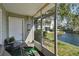 Enclosed lanai overlooking serene waterfront, featuring comfortable seating, and picturesque outdoor views at 6916 Stonesthrow N Cir # 9103, St Petersburg, FL 33710