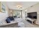 Inviting living room with cozy seating, plush carpet and ample natural light at 6916 Stonesthrow N Cir # 9103, St Petersburg, FL 33710