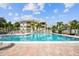 Community pool with lounge chairs, landscaping, and condo buildings at 6916 Stonesthrow N Cir # 9103, St Petersburg, FL 33710