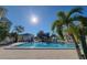 Community pool with blue water and palm trees, offering a relaxing atmosphere at 6916 Stonesthrow N Cir # 9103, St Petersburg, FL 33710