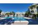 Rectangular community pool surrounded by low rise buildings and mature palm trees at 6916 Stonesthrow N Cir # 9103, St Petersburg, FL 33710