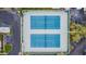 Aerial view of blue tennis courts near condo complex and green landscaping at 6916 Stonesthrow N Cir # 9103, St Petersburg, FL 33710