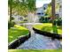 Scenic water feature surrounded by lush green grass and beautiful condo buildings at 6916 Stonesthrow N Cir # 9103, St Petersburg, FL 33710