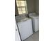 Spacious laundry room featuring a washing machine, dryer, and window at 720 Argyll Dr, Spring Hill, FL 34609