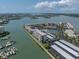 Scenic aerial view of waterfront condo building with boat docks, pool and tennis courts on the water at 7600 Sun Island S Dr # 703, South Pasadena, FL 33707