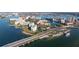 Gorgeous aerial view of a waterfront property with white buildings, lush landscaping, and bridge access at 7902 Sailboat Key S Blvd # 206, South Pasadena, FL 33707