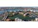Stunning aerial view of waterfront community featuring modern buildings, lush landscaping, boat docks, and bridge access at 7902 Sailboat Key S Blvd # 206, South Pasadena, FL 33707