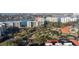 Aerial view showcasing modern condominiums, lush landscaping, and a serene pond in a coastal setting at 7902 Sailboat Key S Blvd # 206, South Pasadena, FL 33707