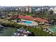 Overhead view of waterfront community showcasing pool, clubhouse, boat dock, and lush surroundings at 7902 Sailboat Key S Blvd # 206, South Pasadena, FL 33707