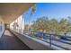 Exterior balcony view showing trees and cars parked in the parking lot at 7902 Sailboat Key S Blvd # 206, South Pasadena, FL 33707