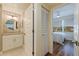 Bright bathroom leads to a bedroom and features a modern vanity and neutral tones at 7902 Sailboat Key S Blvd # 206, South Pasadena, FL 33707