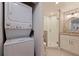 Modern bathroom with a stand-up shower, vanity, and stackable washer and dryer at 7902 Sailboat Key S Blvd # 206, South Pasadena, FL 33707