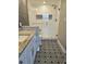 Bathroom features a white vanity, patterned tile flooring, and a frameless glass shower at 7902 Sailboat Key S Blvd # 206, South Pasadena, FL 33707