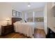 Cozy bedroom with a queen bed, ceiling fan, and a beautiful window view at 7902 Sailboat Key S Blvd # 206, South Pasadena, FL 33707