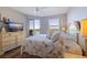 Bedroom features balcony access with waterfront views, a ceiling fan, and coastal decor at 7902 Sailboat Key S Blvd # 206, South Pasadena, FL 33707