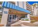 Welcoming condo building entrance with palm trees and professional landscaping at 7902 Sailboat Key S Blvd # 206, South Pasadena, FL 33707