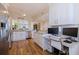 Updated kitchen with white cabinets, granite countertops, stainless steel appliances, workstation and wood flooring at 7902 Sailboat Key S Blvd # 206, South Pasadena, FL 33707