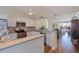 Open kitchen with white cabinets, granite countertops, stainless steel appliances, and breakfast bar overlooking the living area at 7902 Sailboat Key S Blvd # 206, South Pasadena, FL 33707