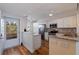 Bright and airy kitchen with white cabinets, granite countertops, stainless steel appliances and wood floors at 7902 Sailboat Key S Blvd # 206, South Pasadena, FL 33707