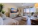 Relax in this cozy living room with water views from the balcony and a mounted television for entertainment at 7902 Sailboat Key S Blvd # 206, South Pasadena, FL 33707