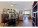 Inviting living room with comfortable seating, natural light, wood floors, adjacent to dining room with water view at 7902 Sailboat Key S Blvd # 206, South Pasadena, FL 33707