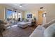 Cozy living room features comfortable seating, neutral tones, and balcony access with outdoor seating at 7902 Sailboat Key S Blvd # 206, South Pasadena, FL 33707