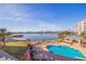 Panoramic view of the waterfront community with a pool, lounge area, and sandy beach at 7902 Sailboat Key S Blvd # 206, South Pasadena, FL 33707
