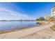 Scenic waterfront view featuring a curved walkway and a modern building against a clear blue sky at 7902 Sailboat Key S Blvd # 206, South Pasadena, FL 33707