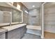 Bathroom featuring a double vanity, large mirror, and a shower-tub combo with tiled walls at 814 15Th Ne St, Ruskin, FL 33570