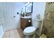 Bathroom with a tiled backsplash, wood vanity and a decorative mirror at 8632 Tahoe Ct # 6, Tampa, FL 33614