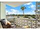 Enjoy city views from the balcony with seating and a decorative privacy screen at 9 Forbes Pl # 206, Dunedin, FL 34698