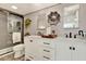 Modern bathroom featuring dual sinks, sleek vanities, and a glass-enclosed shower with stylish tile work at 9 Forbes Pl # 206, Dunedin, FL 34698