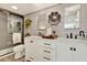 Stylish bathroom with a double sink vanity, decorative tile flooring, and glass enclosed shower at 9 Forbes Pl # 206, Dunedin, FL 34698