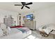 Well-lit bedroom featuring a ceiling fan, tile floors, and soft accent throw rug at 9 Forbes Pl # 206, Dunedin, FL 34698