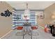 Modern dining room with glass table, unique decor, and stylish seating, perfect for entertaining guests at 9 Forbes Pl # 206, Dunedin, FL 34698