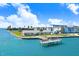 Picturesque waterfront view highlighting a private dock in a serene community setting at 9 Forbes Pl # 206, Dunedin, FL 34698