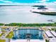 Exterior shot of beachfront condos featuring beautiful views of clear blue seas on a sunny day at 9 Forbes Pl # 206, Dunedin, FL 34698