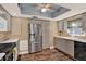 Well-lit kitchen featuring gray cabinets, stainless steel appliances, and modern fixtures at 9 Forbes Pl # 206, Dunedin, FL 34698