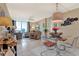 Open-concept living area featuring a dining space, balcony access and serene views of the ocean at 9 Forbes Pl # 206, Dunedin, FL 34698