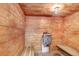 Relaxing wood-paneled sauna room with benches and traditional heater at 9 Forbes Pl # 206, Dunedin, FL 34698