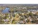 Aerial view of a residential area bordering a river, showcasing a mix of homes and green spaces at 11124 Corlett Rd, Riverview, FL 33578