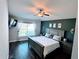 Bedroom with dark accent wall, ceiling fan, and a window letting in natural light at 14358 Edinburgh Moor Dr, Wimauma, FL 33598