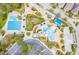 Aerial view of community amenities including multiple pools, covered seating, and a playground at 15944 Ternglade Dr, Lithia, FL 33547