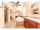Beautiful bathroom featuring a jetted tub, double vanities, walk-in shower and tile flooring at 15944 Ternglade Dr, Lithia, FL 33547