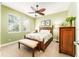 Green bedroom features decorative bed frame and a ceiling fan at 15944 Ternglade Dr, Lithia, FL 33547