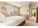 Neutral bedroom with a comfortable bed and a vintage dresser at 15944 Ternglade Dr, Lithia, FL 33547
