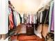 Walk-in closet with wood floors, shelving and ample room for storage at 15944 Ternglade Dr, Lithia, FL 33547